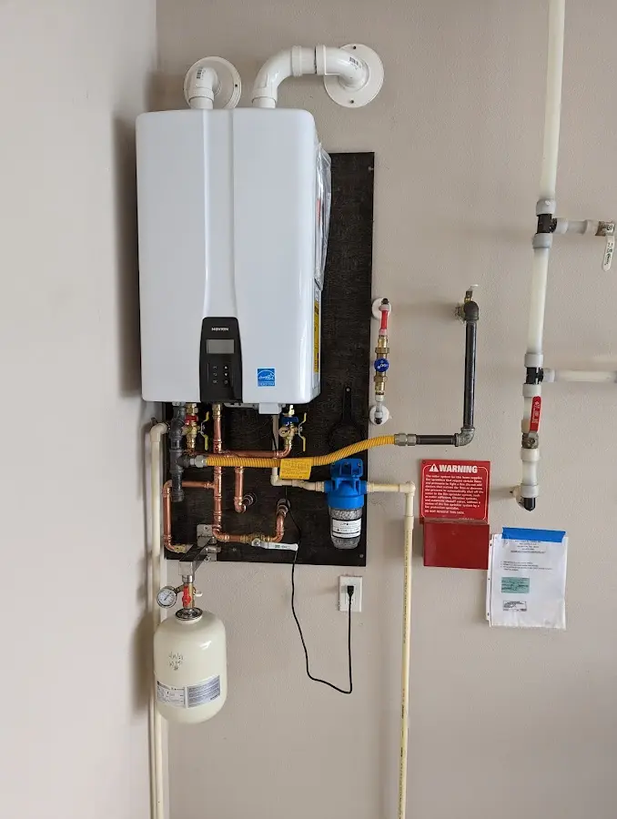 Professional plumber installing copper piping in a Berkley home